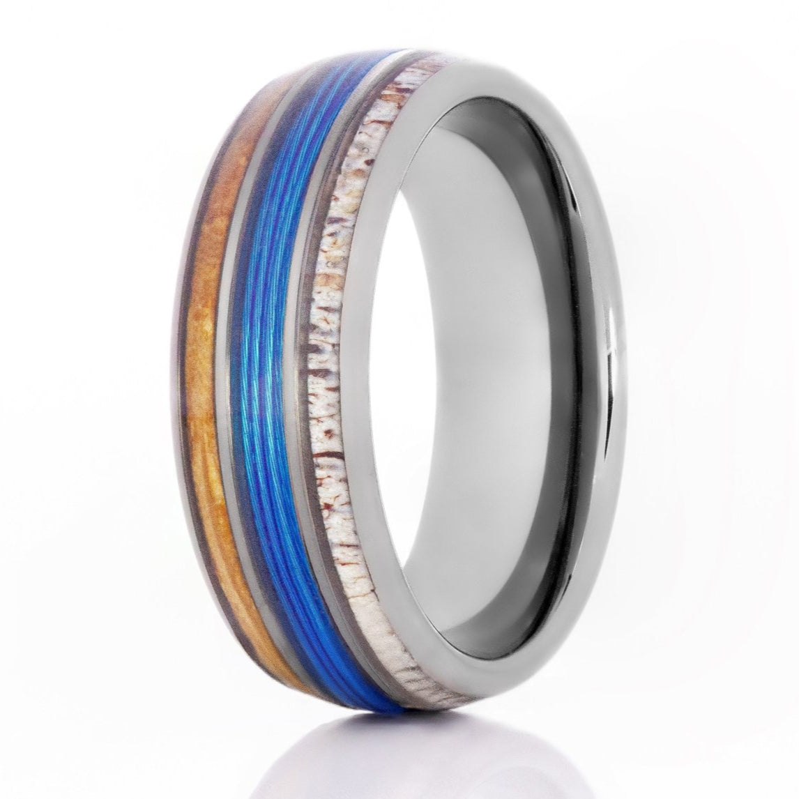 The Adventurer, a silver tungsten carbide ring with a polished finish that features a blue fishing line inlay in the center, and a whiskey barrel wood and deer antler inlay.