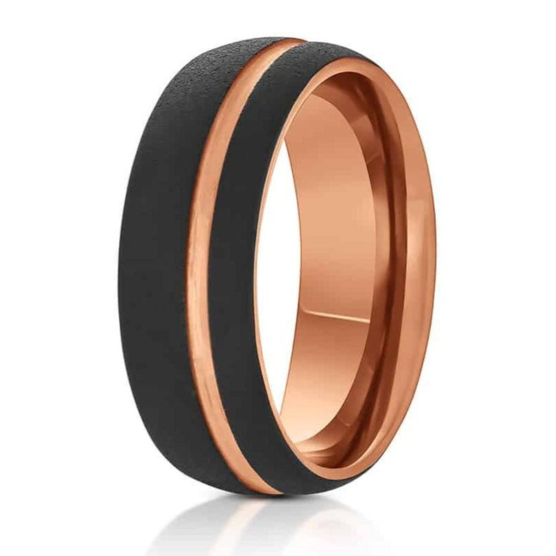 The Appalachian, a 8mm black tungsten carbide ring with a sandstone finish and polished rose gold groove and inner band.