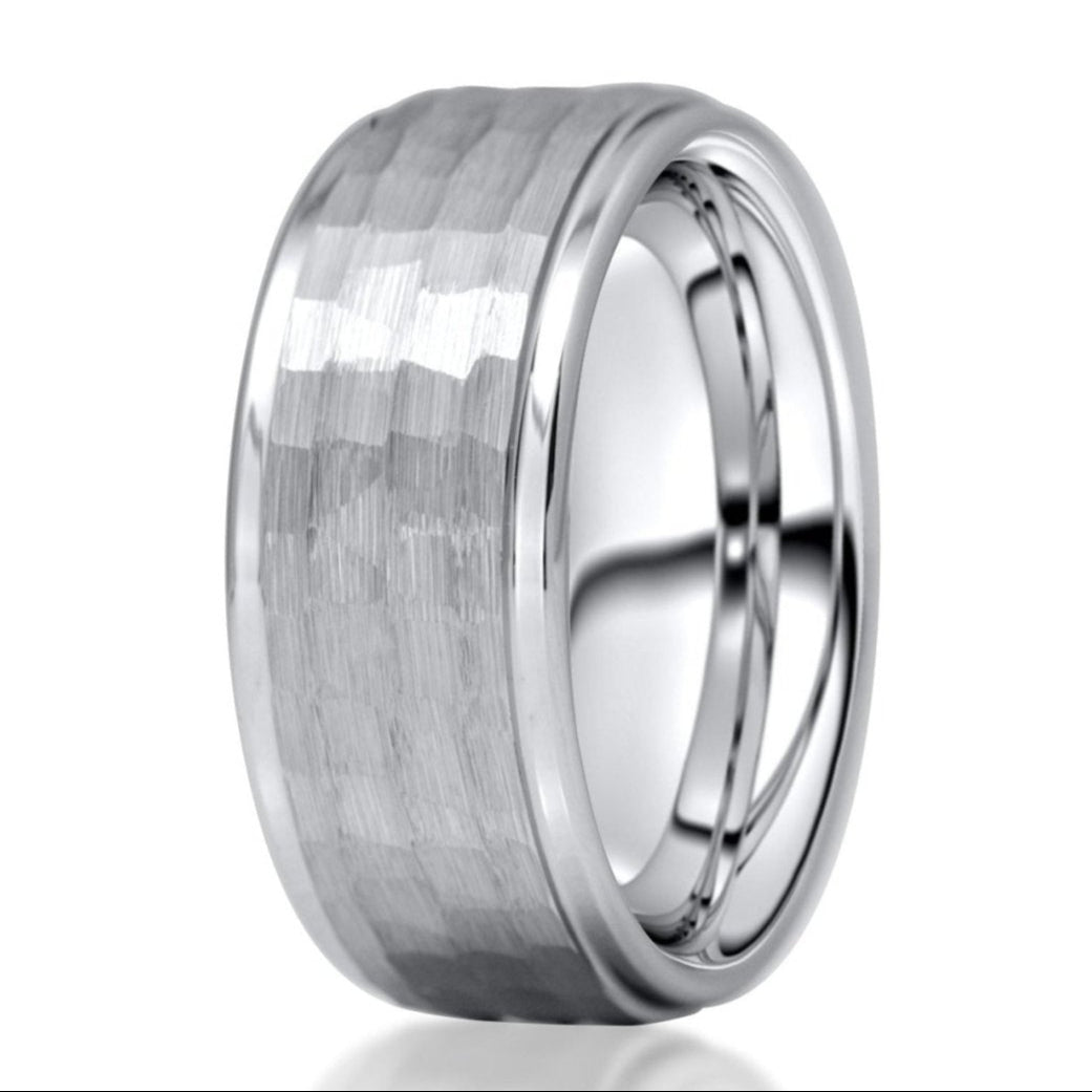 The Knight, a silver tungsten carbide ring that features a hammered and brushed center with polished beveled edges.