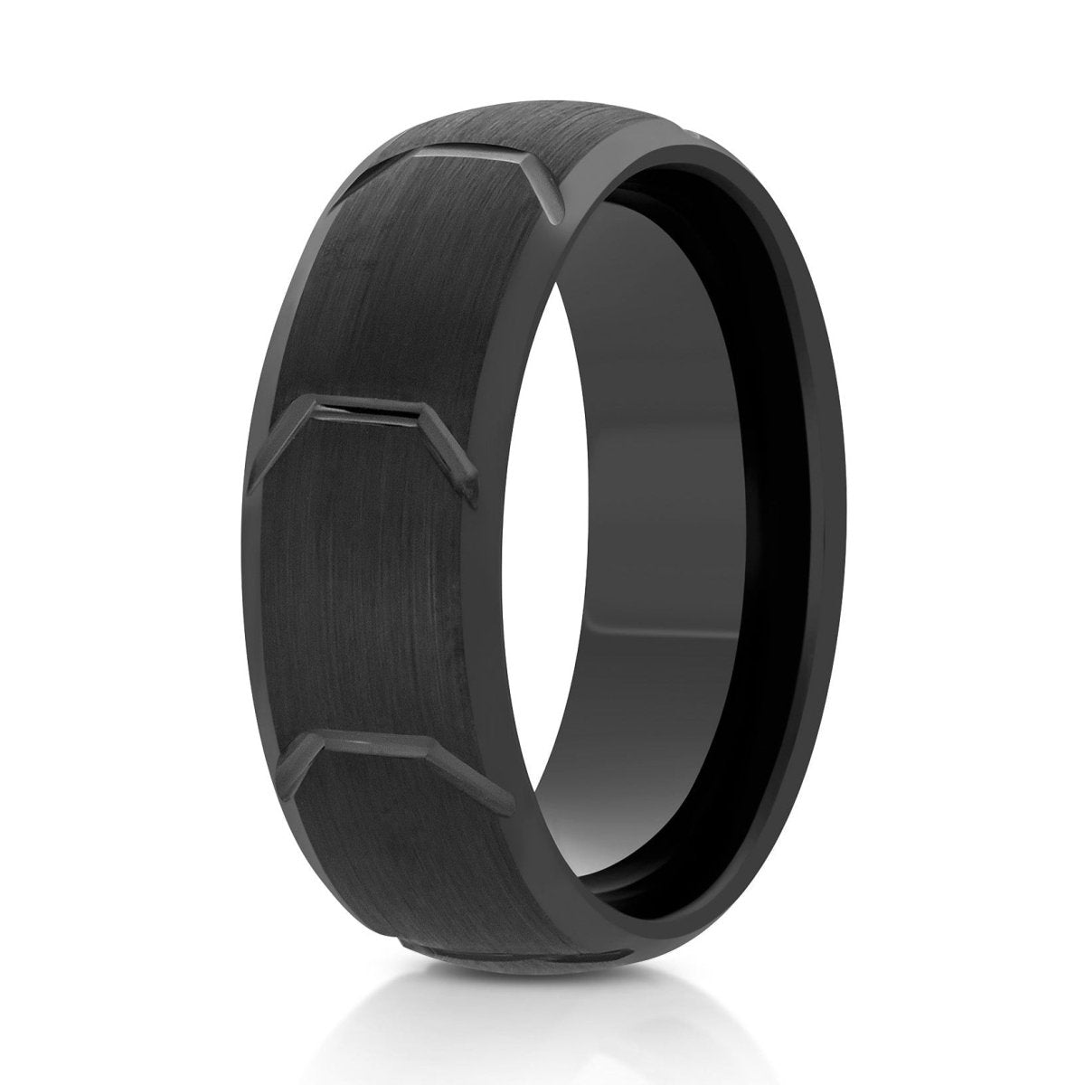The Torque, a 8mm black tungsten ring that features a brushed center with polished beveled edges and tire tread grooves in the center.
