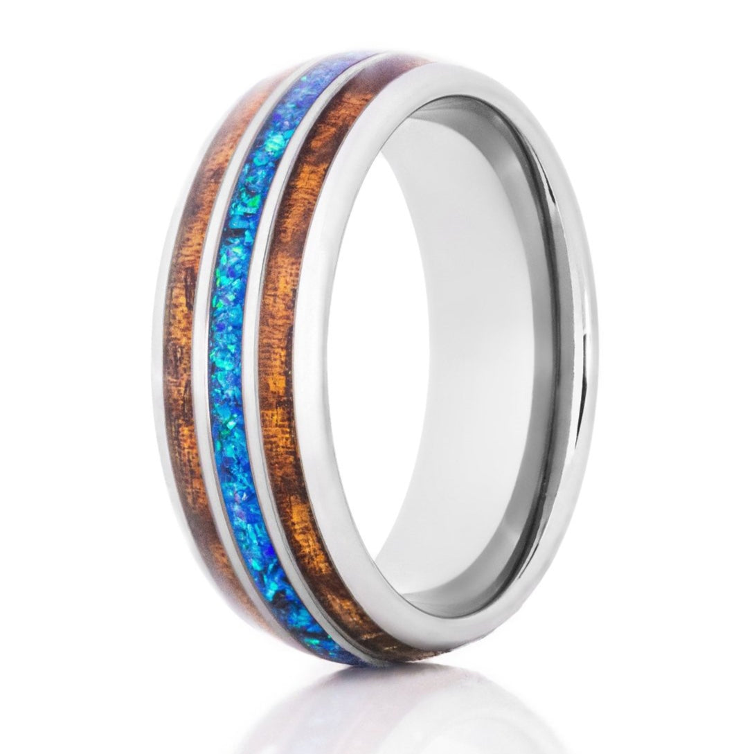 The Surfer, a silver tungsten ring with a polished finish that features a Hawaiian Koa wood and blue opal inlay