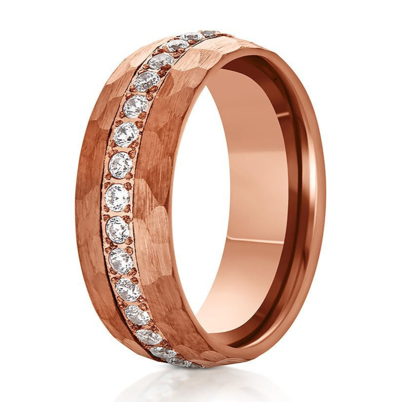 The Muscovy, a 8mm rose gold tungsten carbide ring that features a hammered and brushed finish and CZ diamonds in the center.