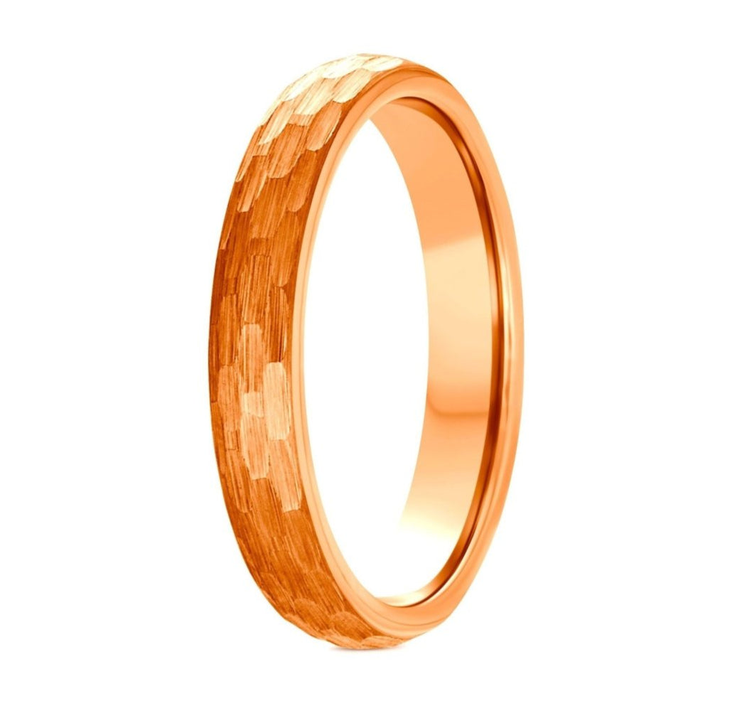 The Passive, a rose gold tungsten carbide 4mm ring that features a hammered and brushed finish with a polished band.