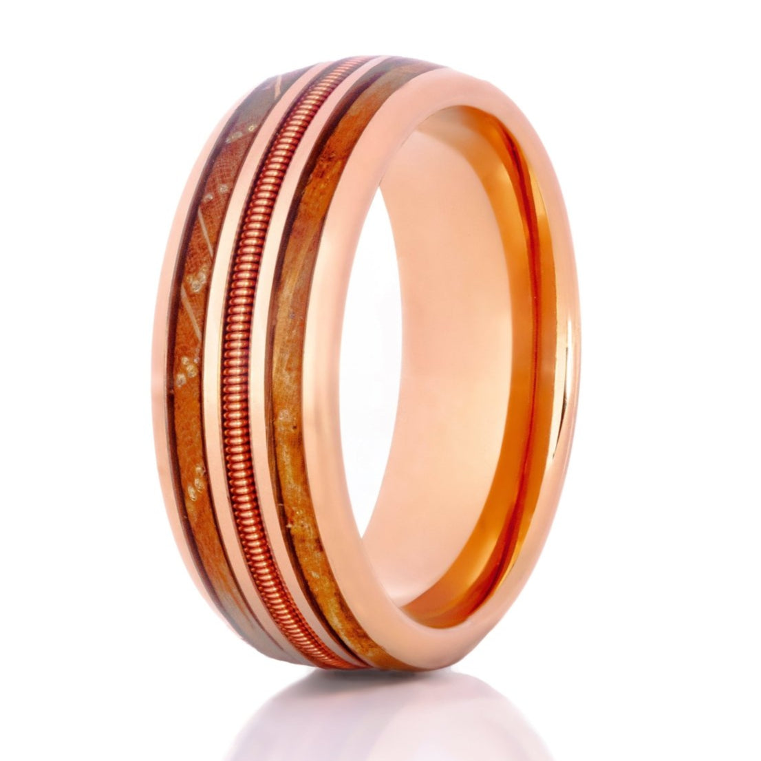The Acoustic, a 8mm rose gold tungsten carbide ring with a polished finish that features a rose gold guitar string in the center and a double whiskey barrel wood inlay.