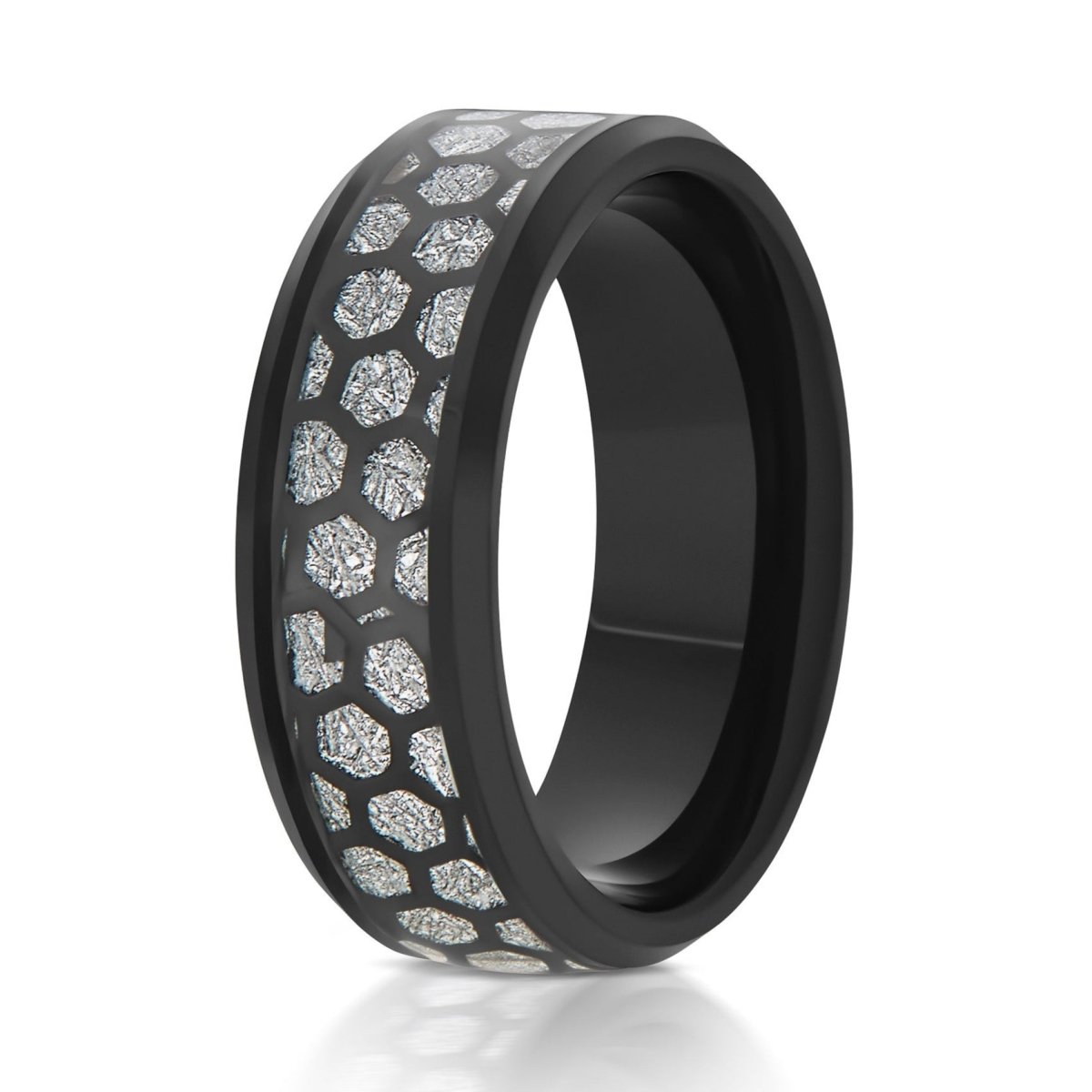 The Asteroid, a 8mm black tungsten ring with a polished finish and beveled edge that features a black honeycomb cut-out over a silver meteorite inlay in the center.