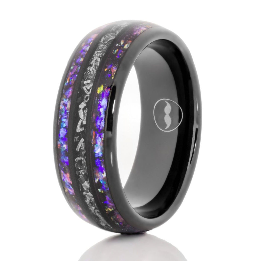 The Callisto, a 8mm black tungsten carbide ring with a polished finish that features a double blue sandstone inlay with a silver meteorite inlay in the center.