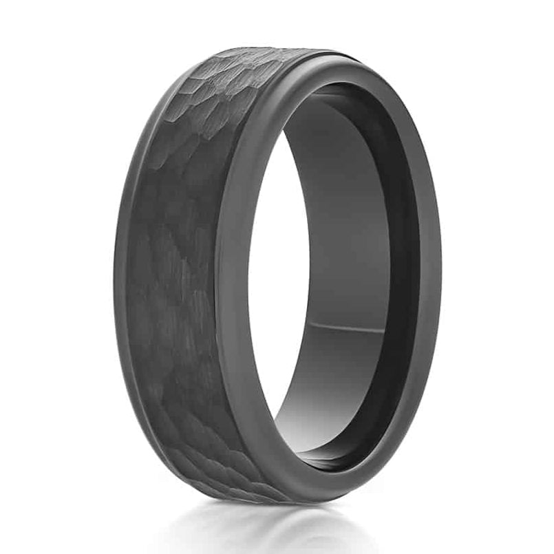 The Client, a black tungsten carbide ring that features a hammered and brushed center with sleek, polished edges.