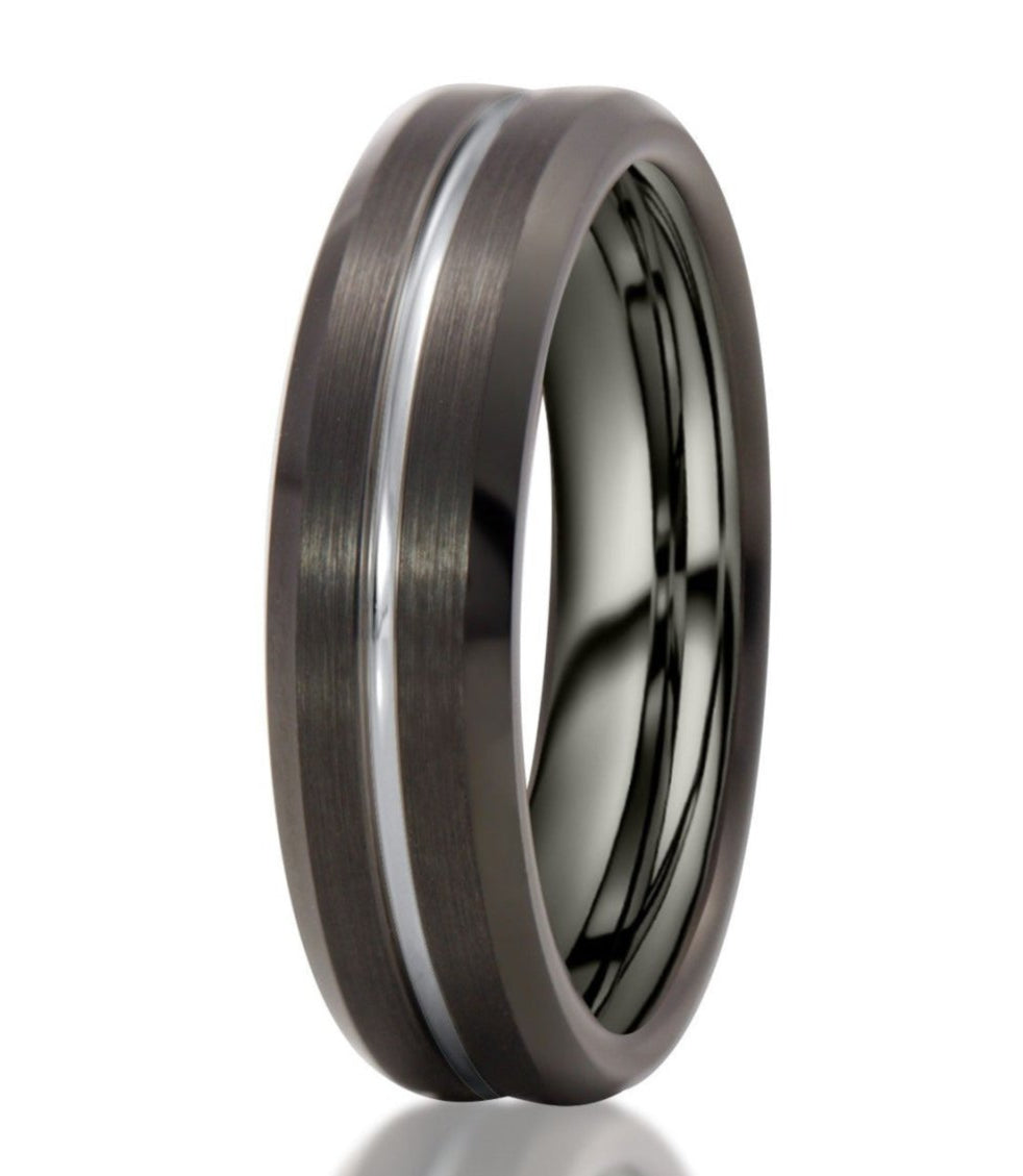 The Comal, a 6mm black tungsten ring with a brushed finish and polished edges, features a silver grooved center.