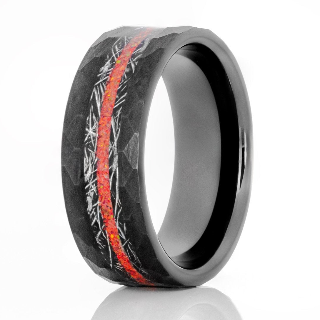 The Firefly, a black tungsten ring with a hammered and brushed finish that features a meteorite and fire red opal inlay.