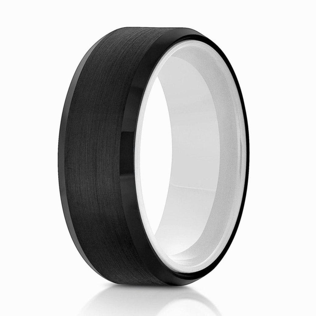 The Jackson, a black tungsten carbide ring with a brushed center and polished edges that features a ceramic white inner sleeve.