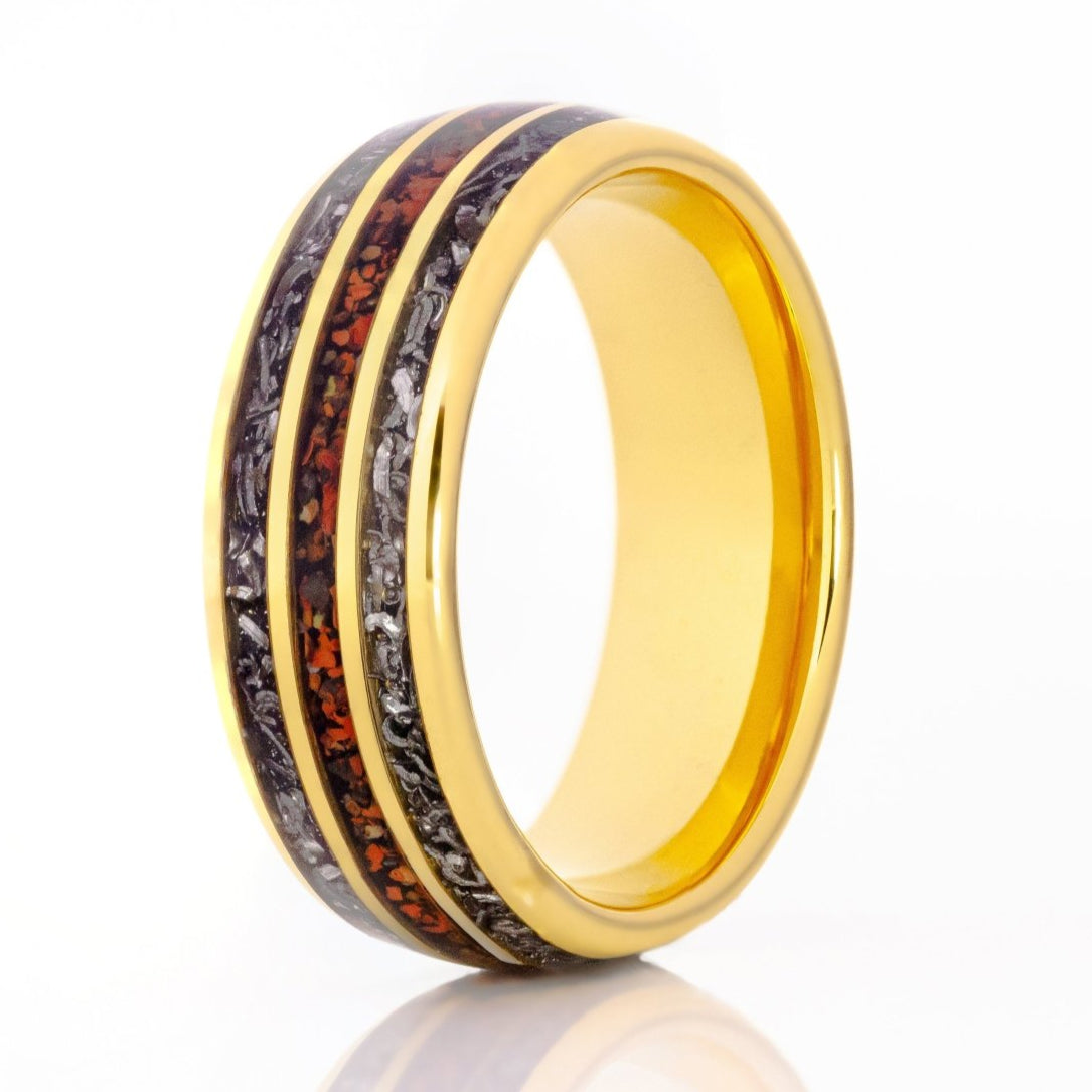 The Moon Crater, a 8mm gold tungsten carbide ring with a polished finish, with a silver double meteorite inlay and red dinosaur bone inlay in the center.