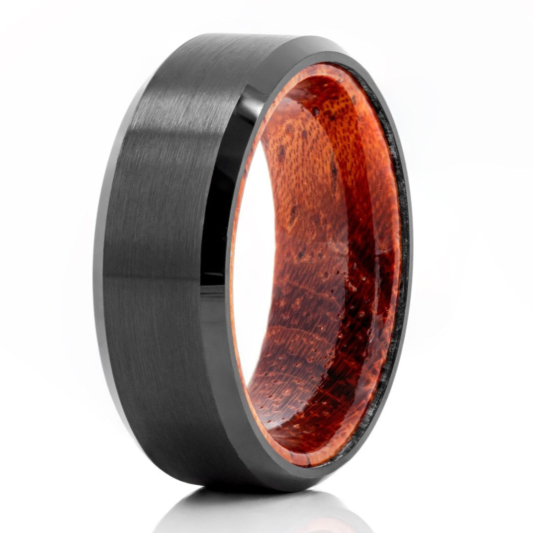 The Nara, a black tungsten carbide scratch-resistant ring with a brushed center and sleek, polished edges with a mahogany wood band.