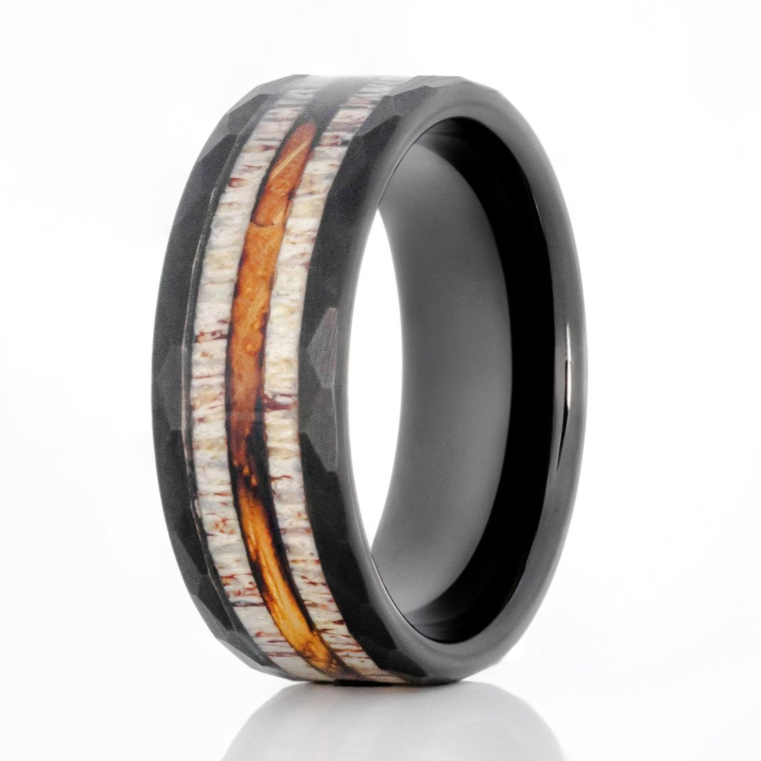 The Neat, a 8mm black tungsten carbide ring with a hammered and brushed finish that features a double deer antler and whiskey barrel wood inlay in the center.