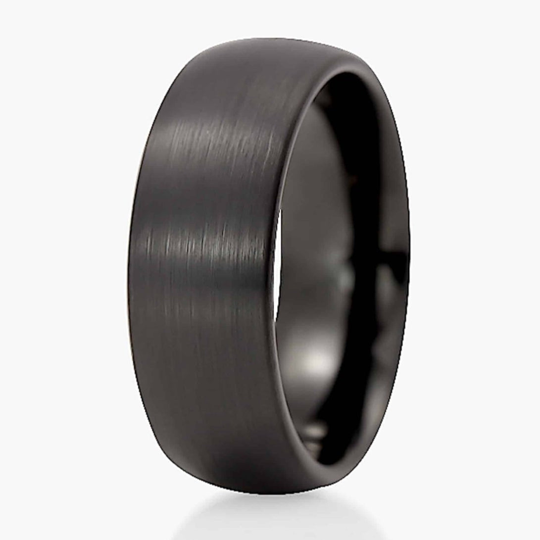The Novelist, a 8mm domed black tungsten carbide ring that features a brushed finish.