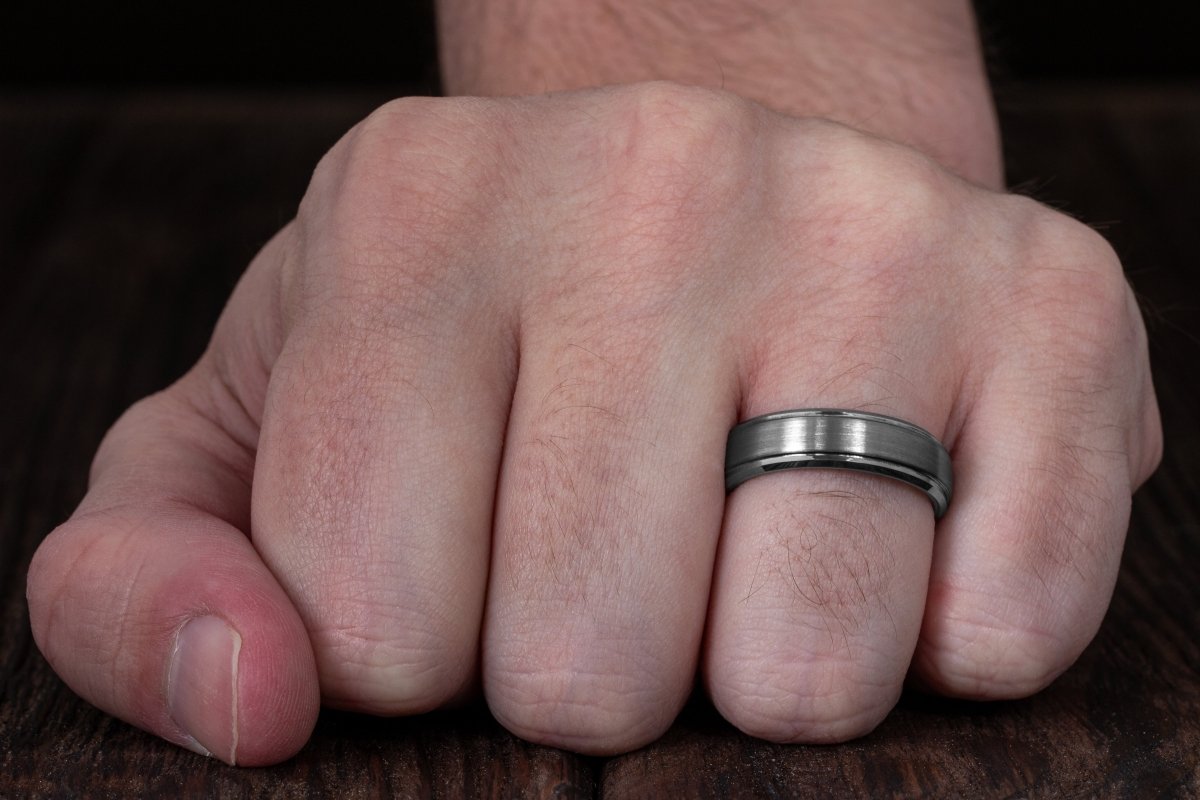 The Sharptail, brushed silver tungsten wedding band or anniversary ring on hand.