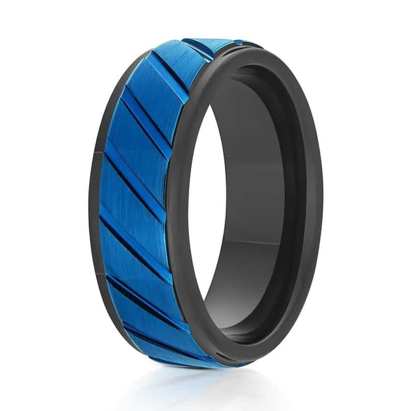 The Tikal, a black and blue tungsten carbide ring that features a brushed center with diagonal grooves and polished edges.