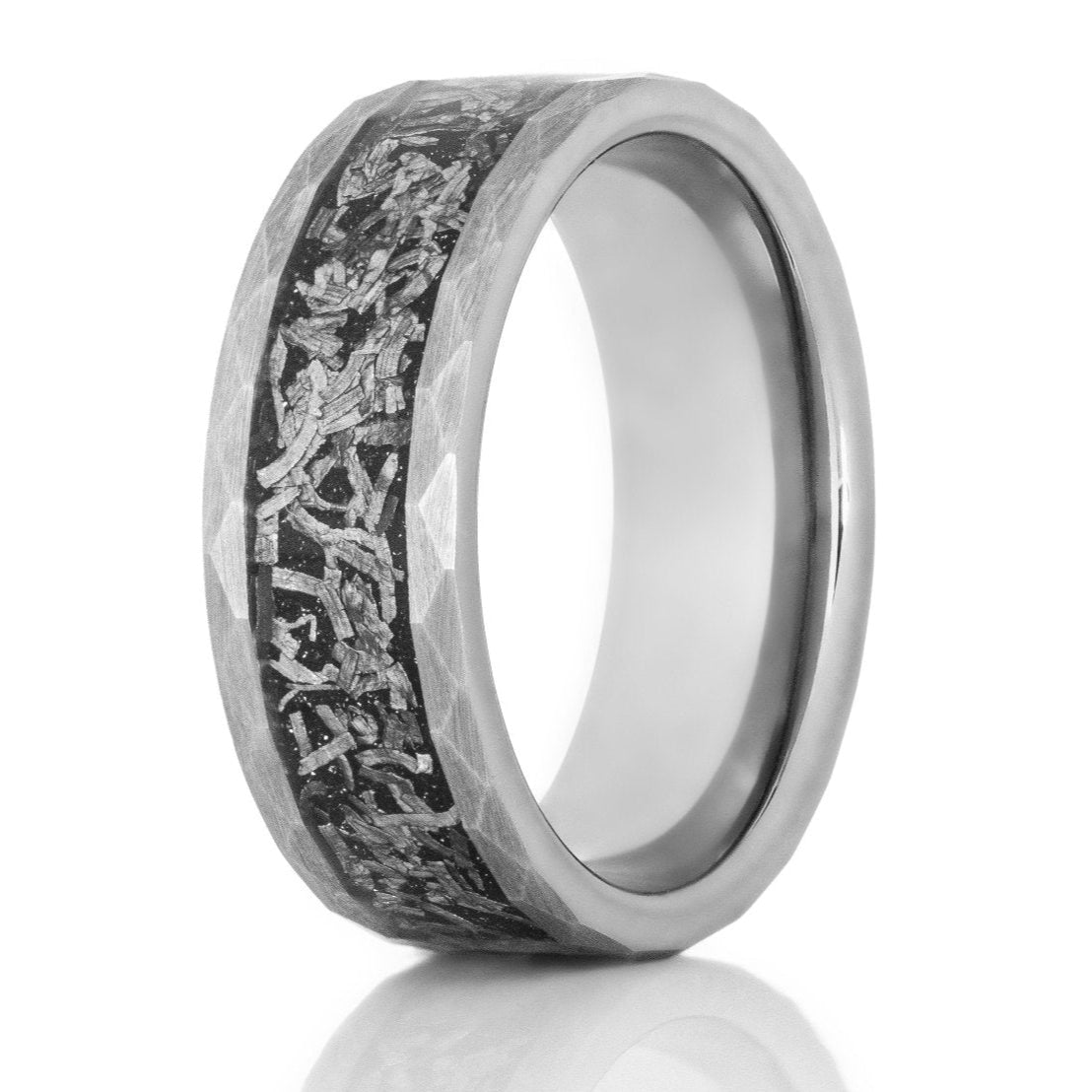 The Crater, a silver tungsten carbide scratch resistant ring that features a hammered and brushed finish and a black and silver meteorite inlay.