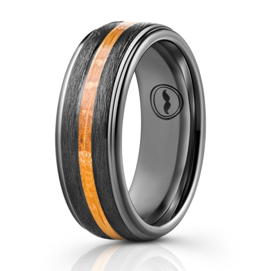 The Moonshine, a black tungsten carbide ring that features a brushed center with polished edges and a whiskey barrel wood inlay.