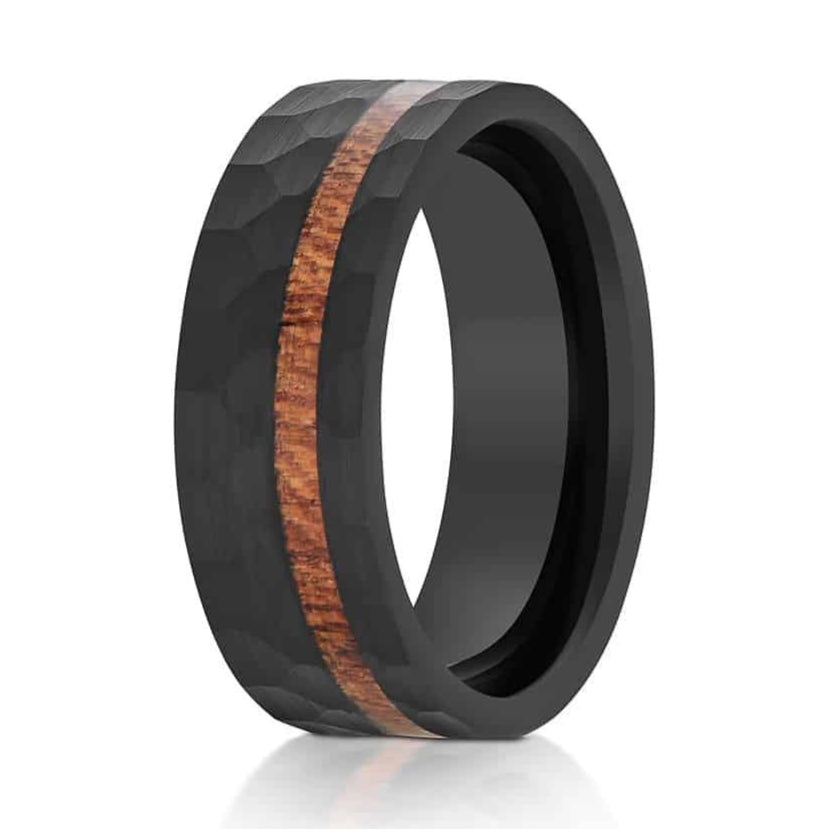 The Alstrom, a black tungsten carbide 8mm ring with a hammered and brushed finish and a Hawaiian Koa Wood inlay.