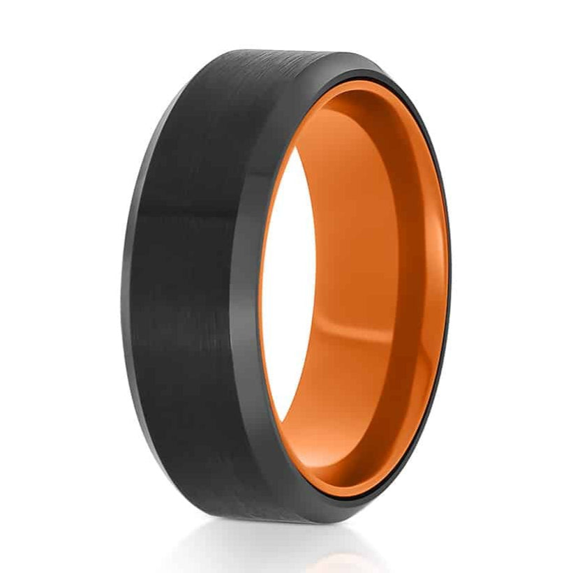 The Doire, a black tungsten ring with a brushed center and polished edges that features an orange, aluminum inner sleeve.