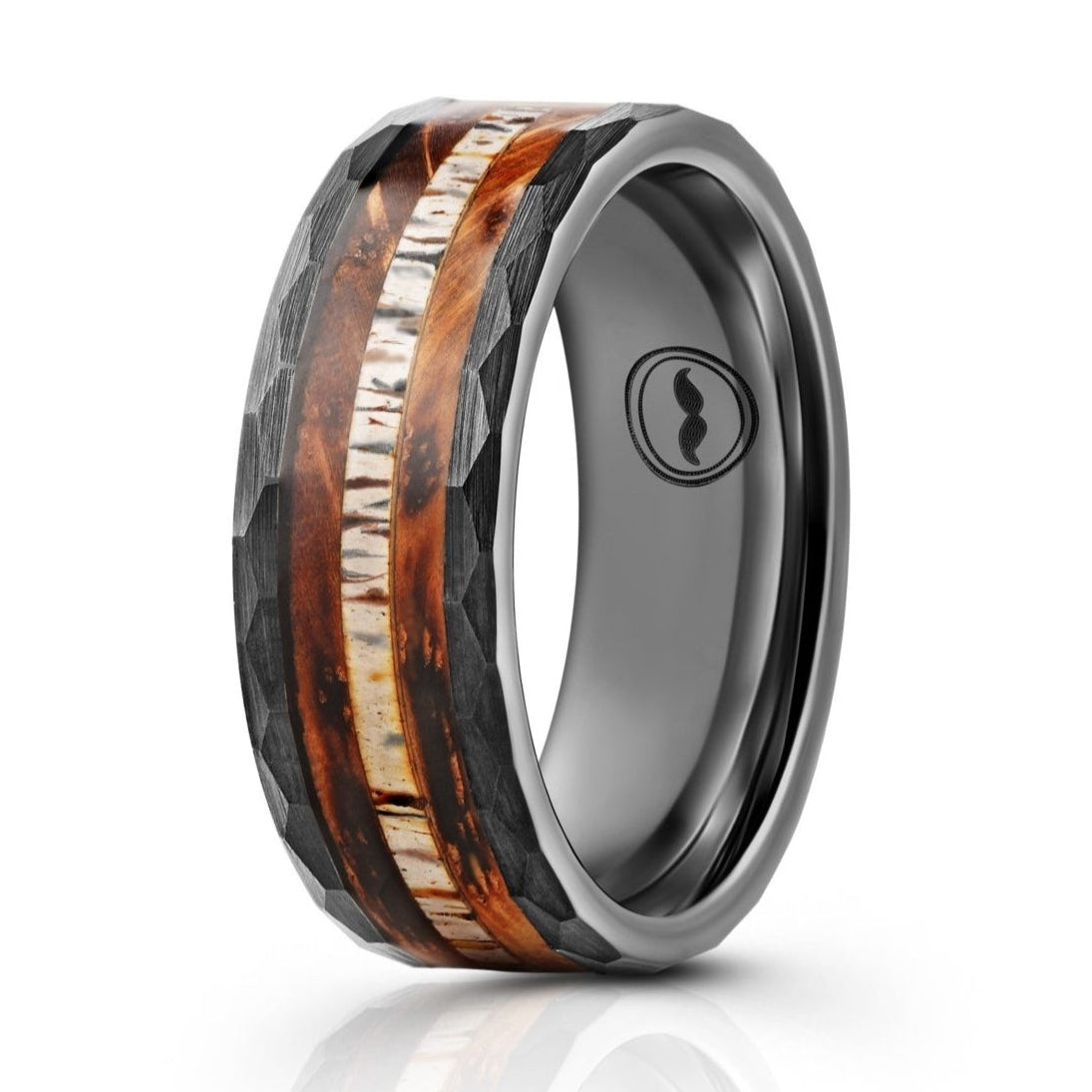 The Charred, a black tungsten carbide ring that features a hammered and brushed finish and a charred whiskey barrel and antler inlay.