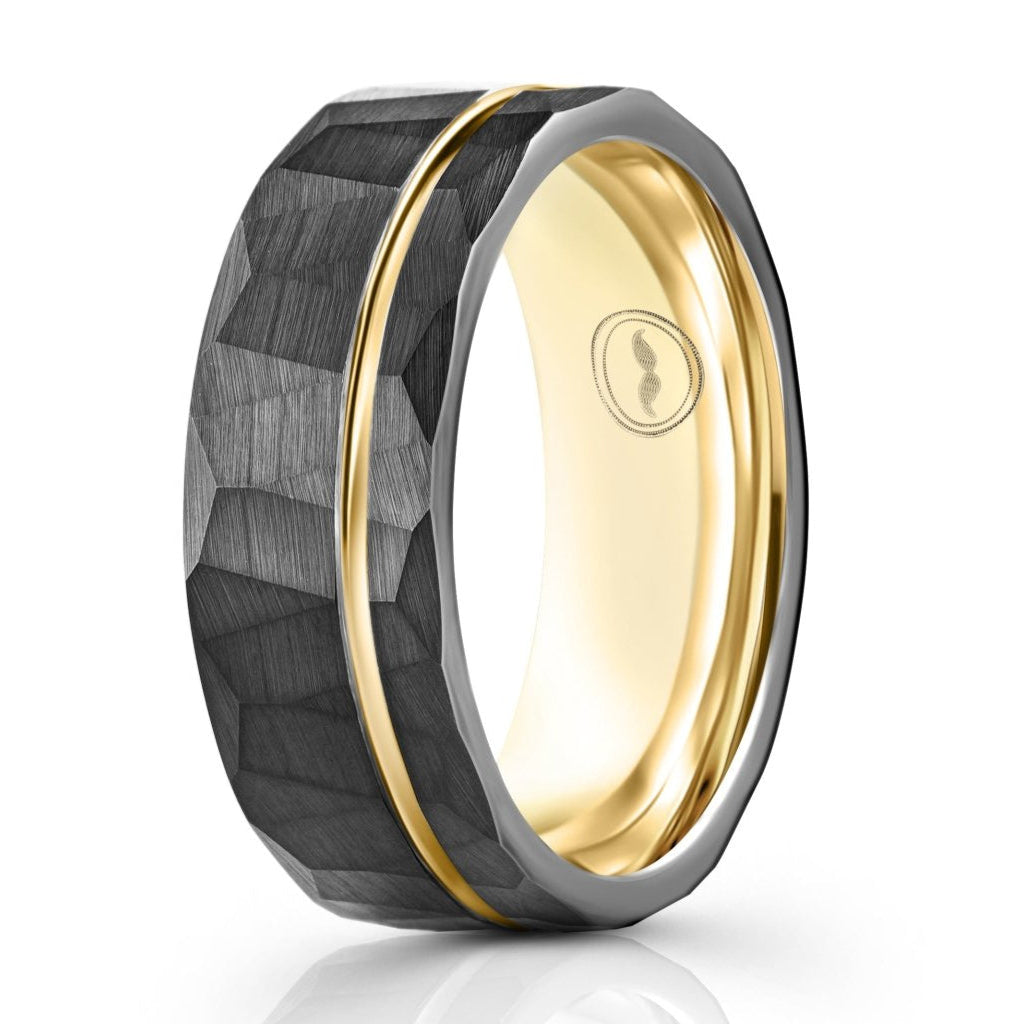The Golden Warrior, a black tungsten carbide scratch resistant ring that features a hammered and brushed finish with a gold polished groove and inner sleeve.